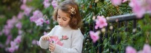 Child Smelling Flowers